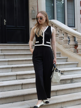 A lady wears a striped chenille vest cardigan